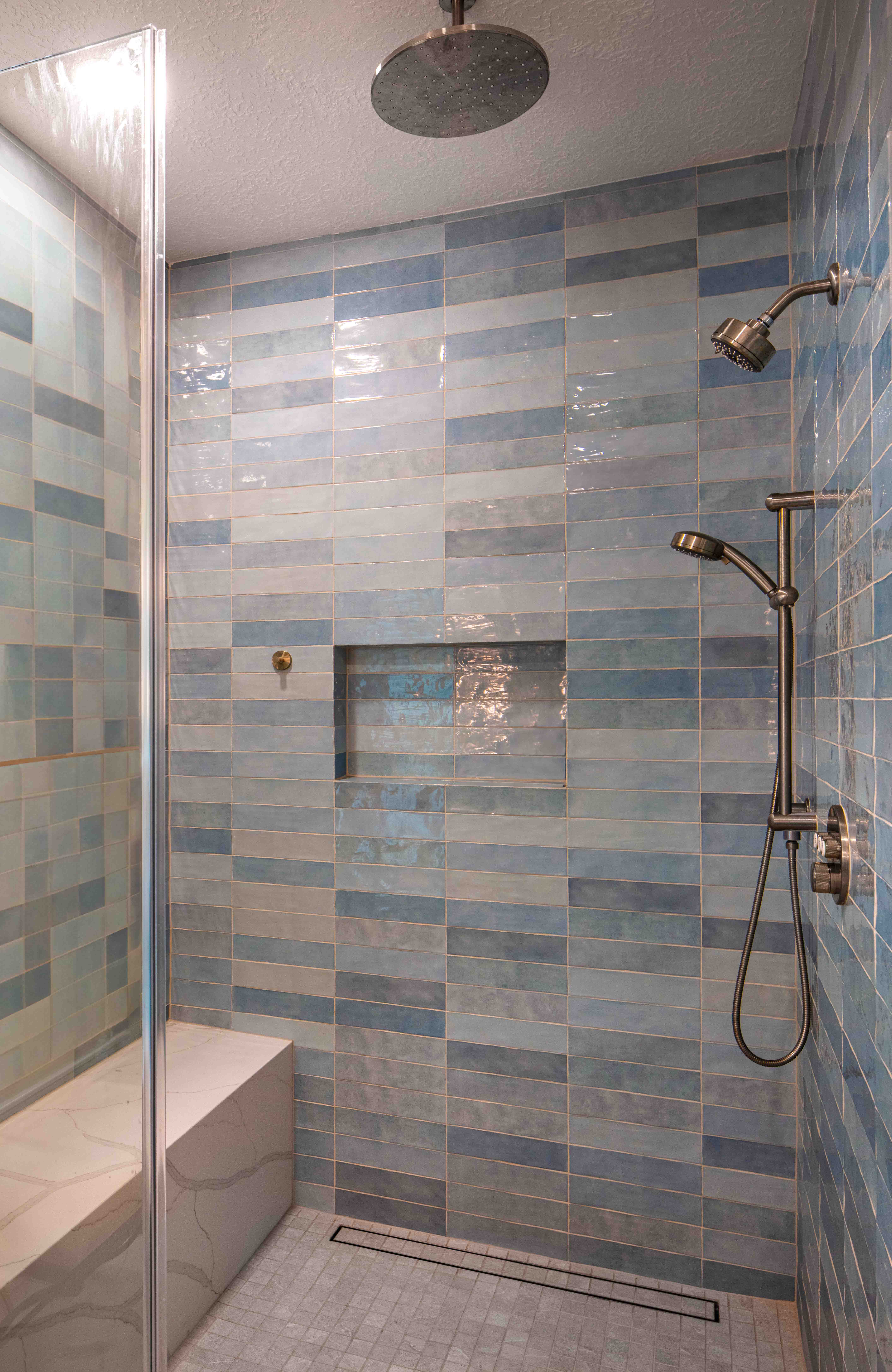 Walk-in shower with bench and blue tile Houston — Matt Baker Contracting